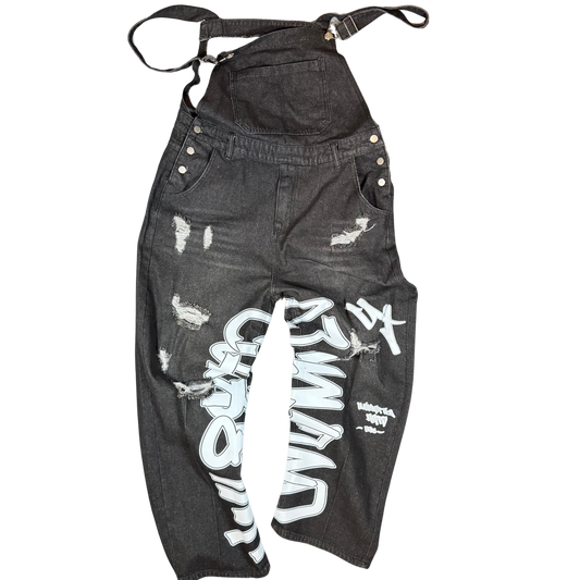 Black distressed BeArt overalls shown from the back with a large graffiti-style “BeArt” chest graphic and oversized Unlimited Arts print down the leg.