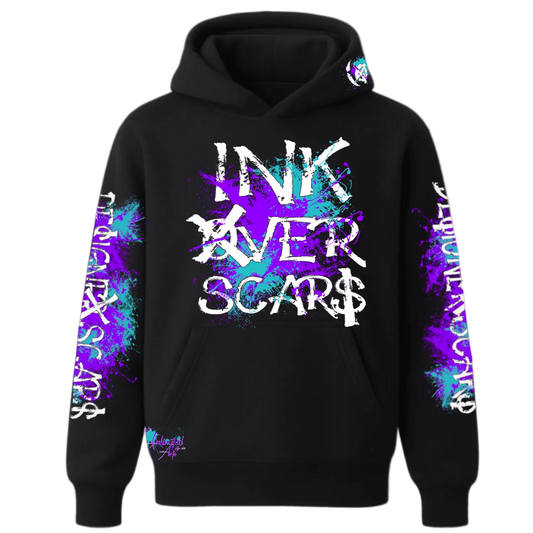 Black hoodie with 'INK OVER SCARS' text and colorful designs on sleeves against a white background