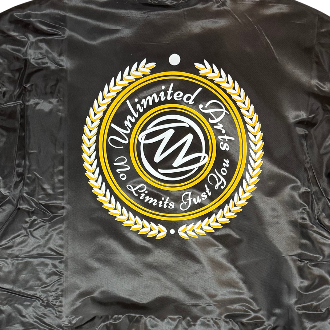 Black satin bomber jacket with a gold and white logo on the back against a white background
