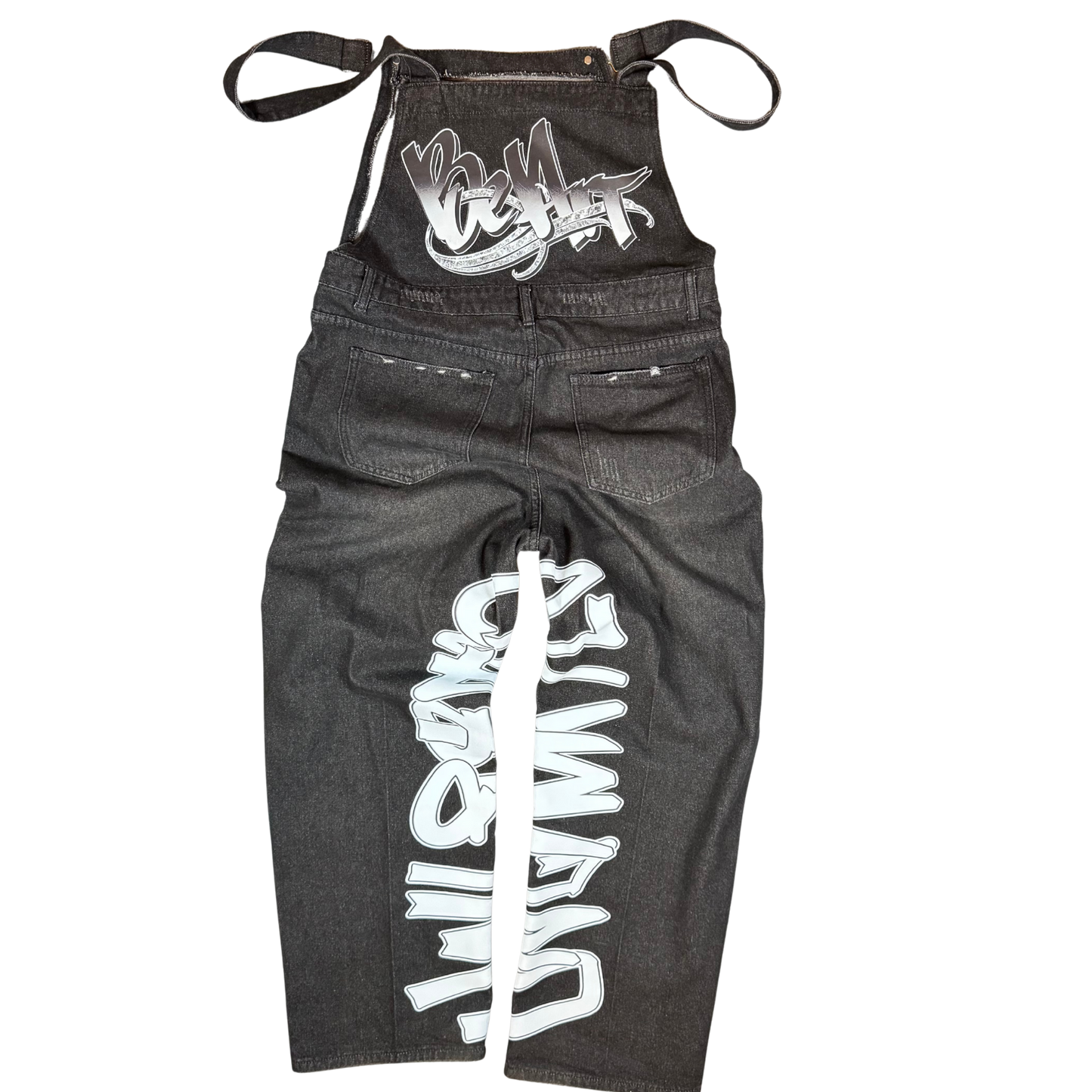 Front view of black distressed BeArt overalls featuring ripped denim, graffiti lettering down the leg, and adjustable straps.