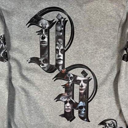 Close-up of gothic Old English UA lettering filled with detailed Day of the Dead skull faces and portrait artwork.