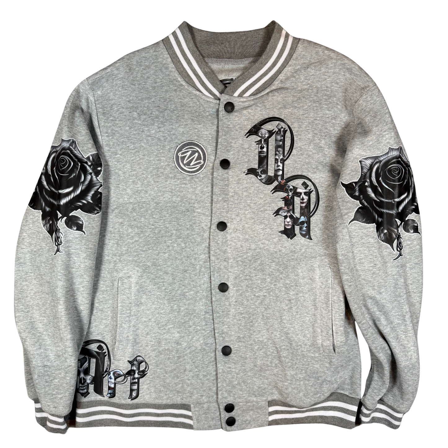 Front view of grey varsity bomber jacket with UA Day of the Dead letter artwork, black rose sleeves, front pockets, and snap-button closure.