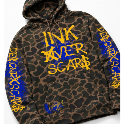 A leopard-print hoodie with yellow and blue graphic text on the front and sleeves, featuring a kangaroo pocket and drawstring hood, photographed on a light gray background.