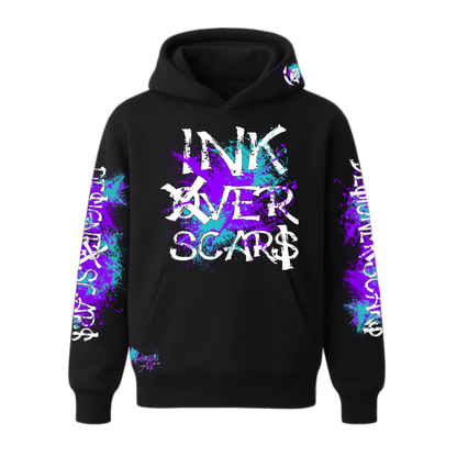 Black hoodie with 'INK OVER SCARS' text and colorful designs on sleeves against a white background