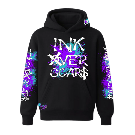 Black hoodie with 'INK OVER SCARS' text and colorful designs on sleeves against a white background