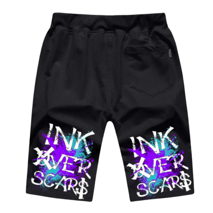 Black shorts with colorful 'INK OVER SCARS' text design on a white background