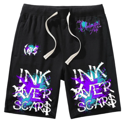 Black shorts with 'INK OVER SCARS' text and colorful designs on a white background