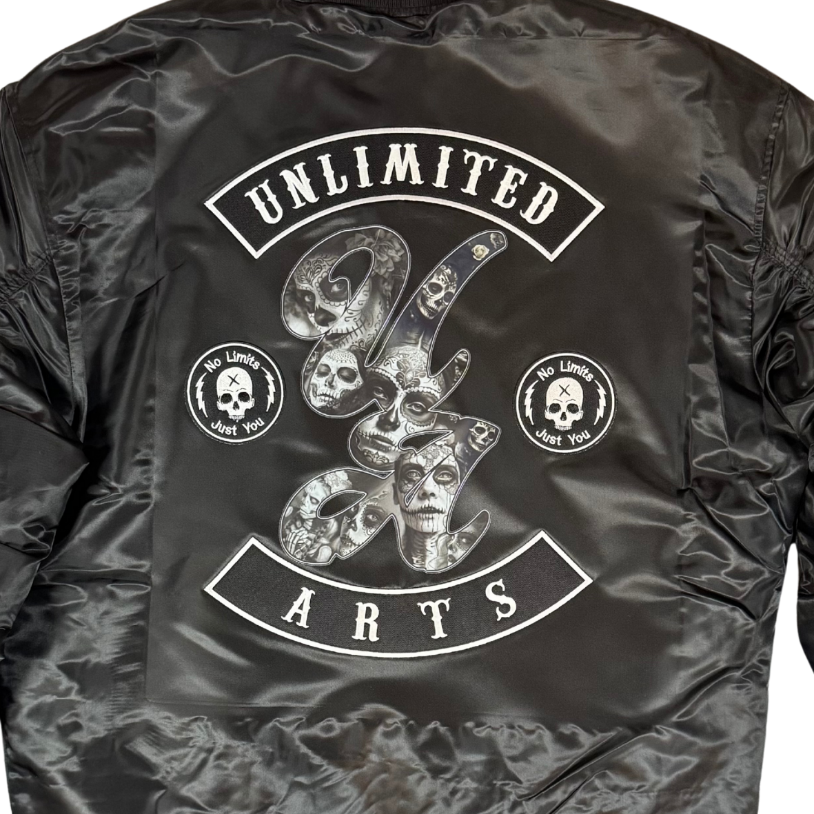 Black bomber jacket with 'Unlimited 94 Arts' logo on the back against a white background